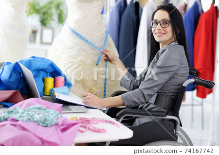 Woman stylist in wheelchair at workplace closeup 74167742
