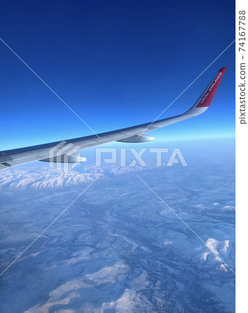Airplane wing against the background of high mountains, Ural Airlines 74167788