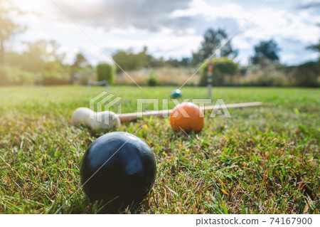 Croquet outdoor game on a lawn 74167900