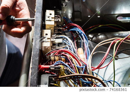 repairman disassembles switch of electric stove repairman disassembles switch of electric stove 74168361