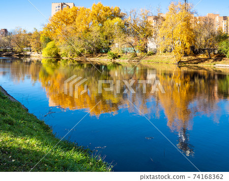 river in urban park in sunny autumn day river in urban park in sunny autumn day 74168362
