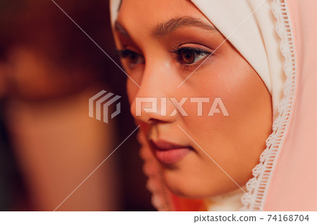 beautiful young woman with a pink hijab. beautiful young woman with a pink hijab. 74168704
