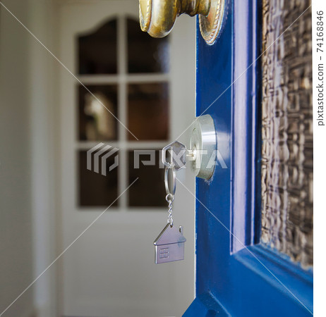 Open door to a new home with key and home shaped keychain. Mortgage, investment, real estate, property and new home concept Open door to a new home with key and home shaped keychain. Mortgage, investment, real estate, property and new home concept 74168846