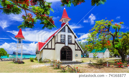 landmarks of  Mauritius island - beautiful Red church on the beach. Cap Malheureux 74168877