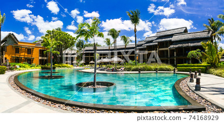 Luxury resort with swimming pool and bungalows. Tropical holidays Luxury resort with swimming pool and bungalows. Tropical holidays 74168929
