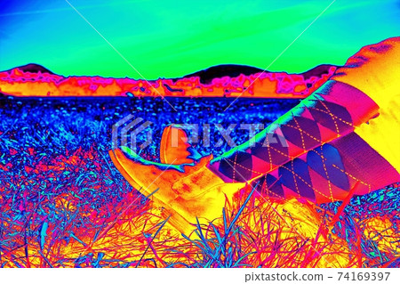 Woman horse rider sit with crossed legs in horse paddock boots and long tights. 74169397