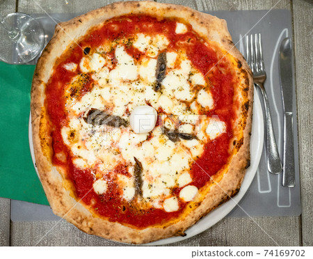 top view of italian pizza Napoli with anchovies 74169702