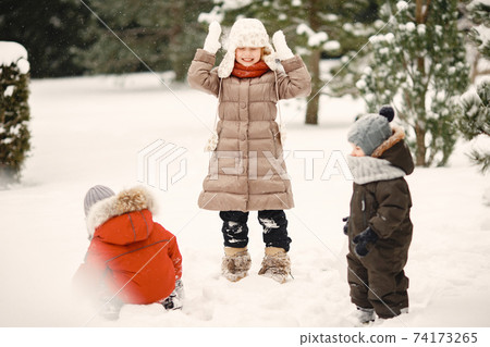 Cute little childrens in a winter park Cute little childrens in a winter park 74173265