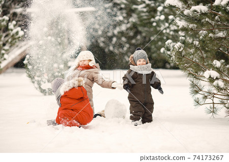 Cute little childrens in a winter park Cute little childrens in a winter park 74173267