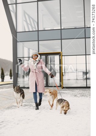 African woman walks with dog outdoors 74173268