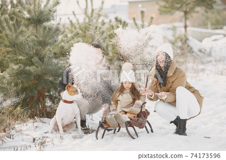 Family in winter clothes play in winter forest Family in winter clothes play in winter forest 74173596