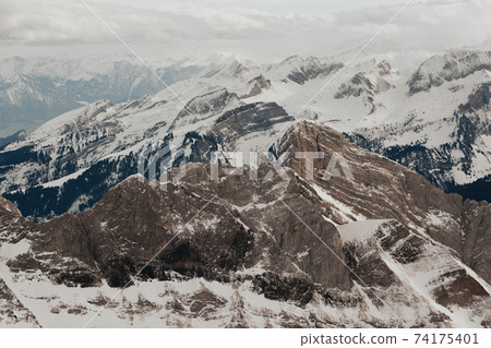 Snow covered swiss alps from above view of mountain Saentis Snow covered swiss alps from above view of mountain Saentis 74175401