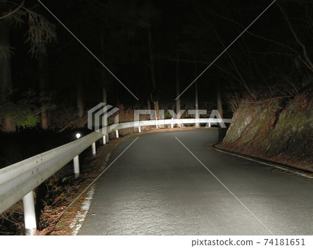 A sharp curve on a mountain road at midnight A sharp curve on a mountain road at midnight 74181651