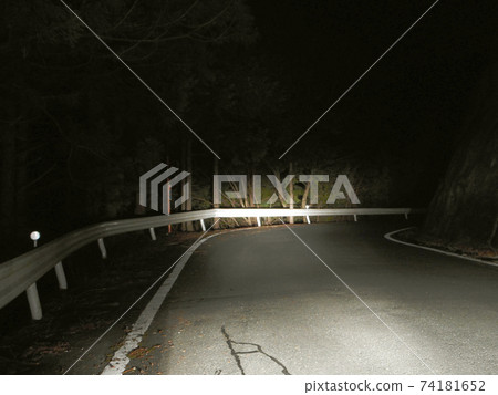 A sharp curve on a mountain road at midnight A sharp curve on a mountain road at midnight 74181652