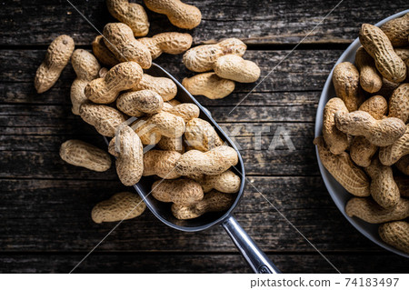 Roasted peanuts. Tasty groundnuts in metal scoop. Roasted peanuts. Tasty groundnuts in metal scoop. 74183497