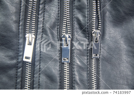 Detail of the metal zippers of the classic black leather jacket. Fashion concept 74183997