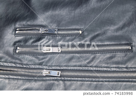 Detail of the metal zippers of the classic black leather jacket. Fashion concept 74183998
