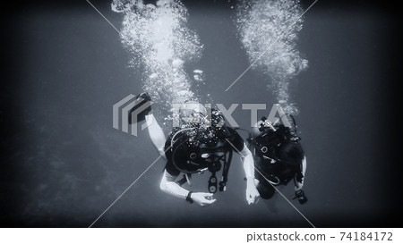 Above the abyss, a diver under water 74184172