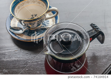 Glass coffee server with hot coffee and empty cup & saucer 74184914