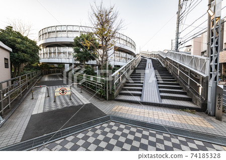 Spiral bike path and sidewalk leading to Tokyo Shiokaze Bridge 74185328