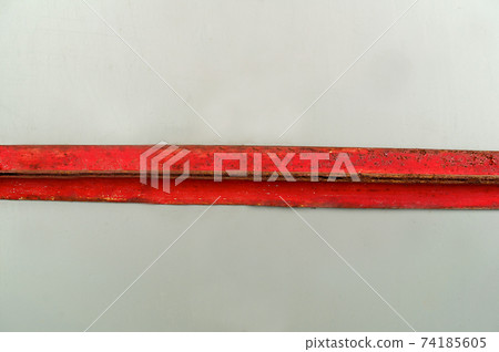 Horizontal metal rusty plate of red color on a light background 74185605