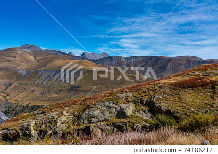 View of the mountains around Alpe d'Huez in the french Alps, France View of the mountains around Alpe d'Huez in the french Alps, France 74186212