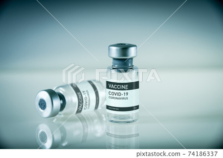 Covid-19 vaccine bottles on a blue background 74186337