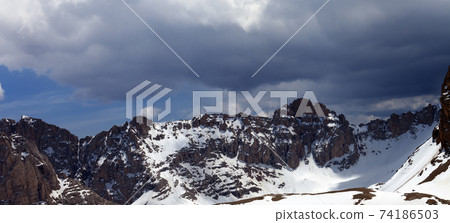 Snow mountains and sky with clouds 74186503