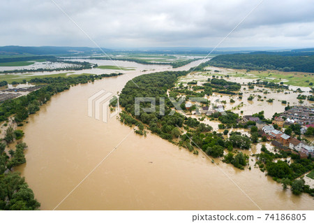 Aerial view of Dnister river with dirty water and  flooded houses in Halych town, western Ukraine. 74186805