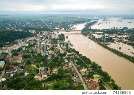 Aerial view of Dnister river with dirty water and  flooded houses in Halych town, western Ukraine. 74186806