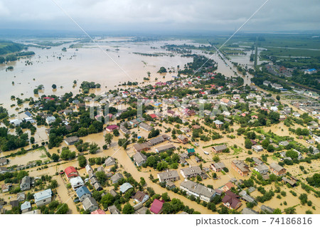 Aerial view of flooded houses with dirty water of Dnister river in Halych town, western Ukraine. 74186816