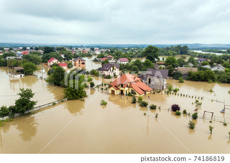 Aerial view of flooded houses with dirty water of Dnister river in Halych town, western Ukraine. Aerial view of flooded houses with dirty water of Dnister river in Halych town, western Ukraine. 74186819