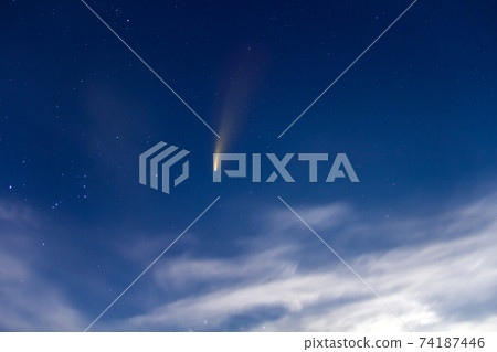 Neowise comet with light tail in dark blue night sky. Neowise comet with light tail in dark blue night sky. 74187446