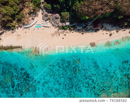 Top view of tropical beach with turquoise sea water in Bali, aerial view Top view of tropical beach with turquoise sea water in Bali, aerial view 74188582