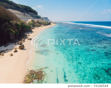 Aerial view of tropical beach with turquoise ocean in Bali, Melasti beach Aerial view of tropical beach with turquoise ocean in Bali, Melasti beach 74188584