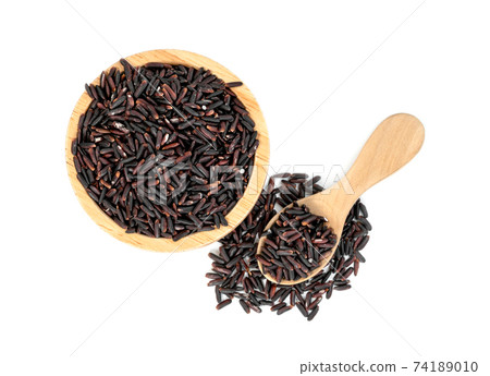 dark violet rice berry with wooden bowl and spoon isolated on white background 74189010