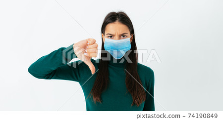 Young sad woman standing over white studio background 74190849