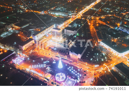 Gomel, Belarus. Main Christmas Tree And Festive Illumination On Lenin Square In Homel. New Year In Belarus. Aerial Night View Gomel, Belarus. Main Christmas Tree And Festive Illumination On Lenin Square In Homel. New Year In Belarus. Aerial Night View 74191011