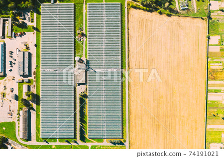 Aerial View Greenhouses For Growing Flowers, Vegetables And Fruits. Agricultural And Industrial Buildings Aerial View Greenhouses For Growing Flowers, Vegetables And Fruits. Agricultural And Industrial Buildings 74191021