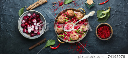 Lamb meatballs in cherry sauce 74192076