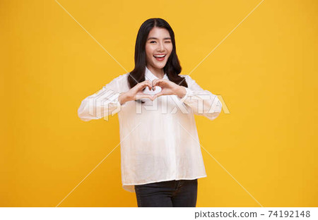 beautiful Asian woman showing heart sign happy valentine concept. beautiful Asian woman showing heart sign happy valentine concept. 74192148