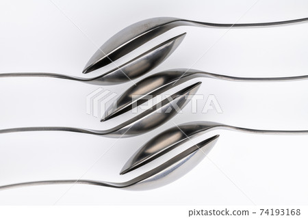 Artistic place setting photo of six spoons falling into each other. Artistic place setting photo of six spoons falling into each other. 74193168
