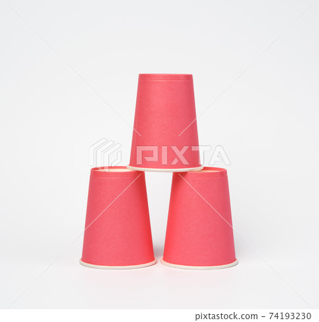 pink paper disposable cups on a white background 74193230