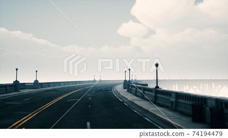 long bridge in misty fog long bridge in misty fog 74194479