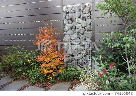 A small garden with a gabion 74195048