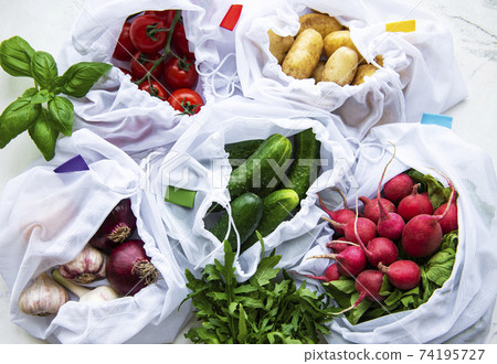 Mesh shopping bag with organic vegetables on marble background. Flat lay, top view. Zero waste, plastic free concept.  Summer fruits. 74195727