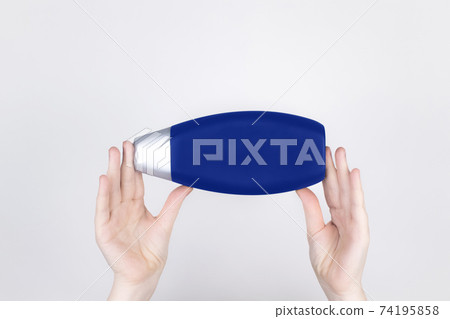 Chemical components of the shampoo. A woman's hand holds a black jar of shampoo. Place for text. Conception of the harm of chemical cosmetics or the benefits of organic chemicals for home Chemical components of the shampoo. A woman's hand holds a black jar of shampoo. Place for text. Conception of the harm of chemical cosmetics or the benefits of organic chemicals for home 74195858