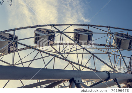 Gray or white metal ferris wheel with closed Gray or white metal ferris wheel with closed 74196478