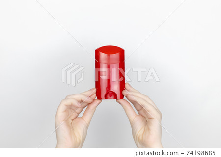 A woman is holding antiperspirant. Place for your text. The concept of hazardous substances in cosmetics and household chemicals A woman is holding antiperspirant. Place for your text. The concept of hazardous substances in cosmetics and household chemicals 74198685