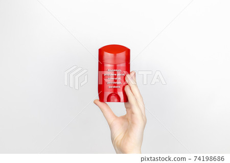A woman examines the harmful ingredients of the antiperspirant. Stick deodorant with aluminum, propylene glycol, mineral oil, petrolatum, parabens. The concept of hazardous substances in cosmetics 74198686